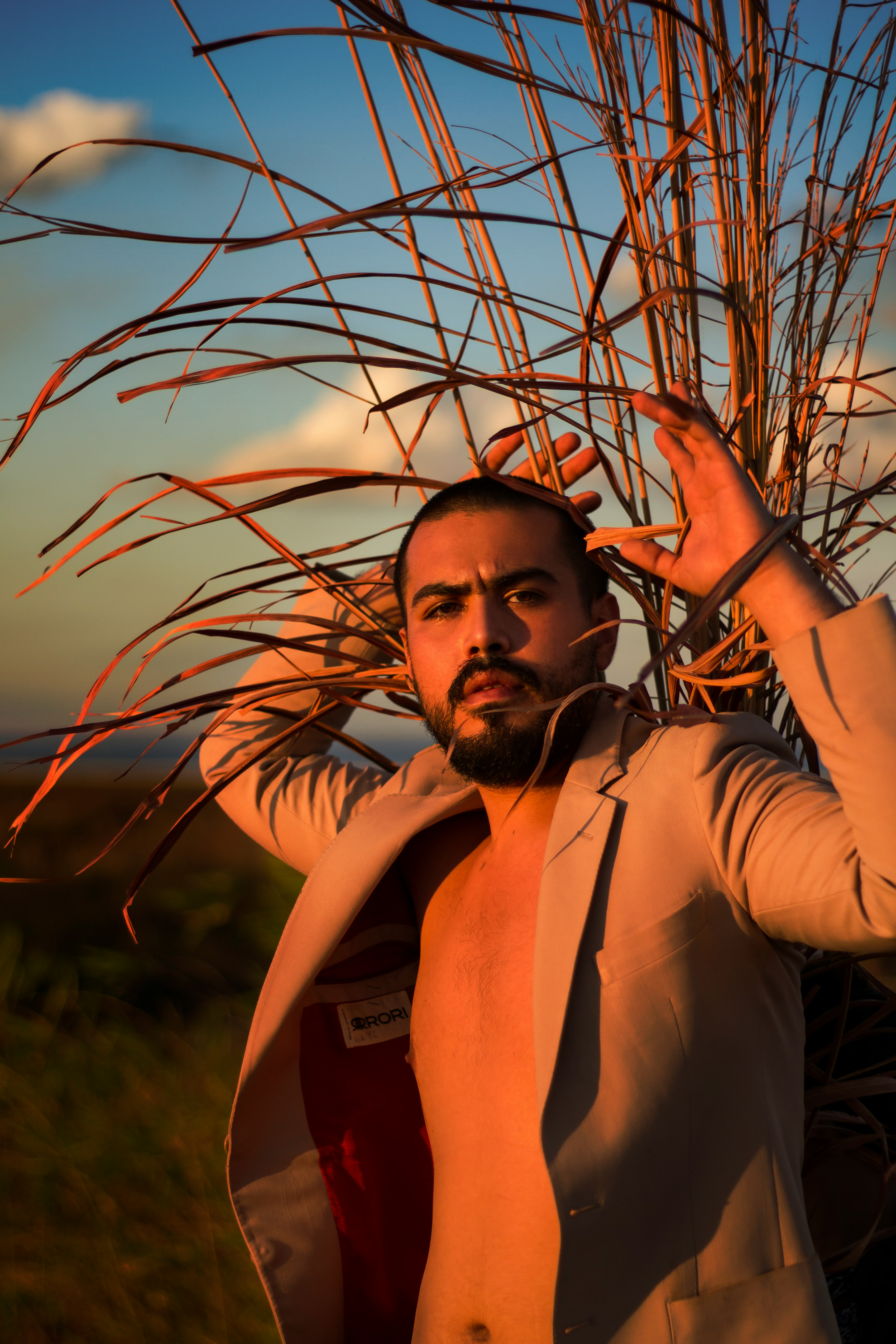 man in white dress shirt standing on grass field during daytime